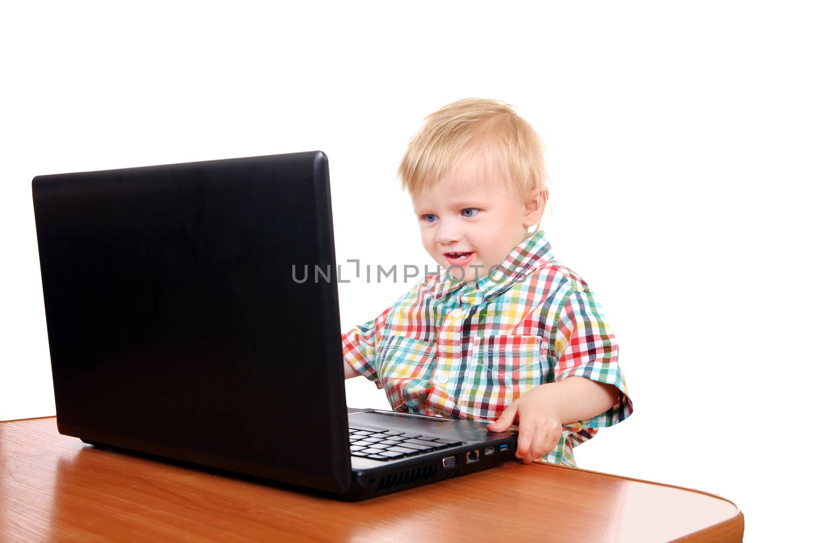 Cheerful Baby Boy playing in Laptop Isolated on the White Background