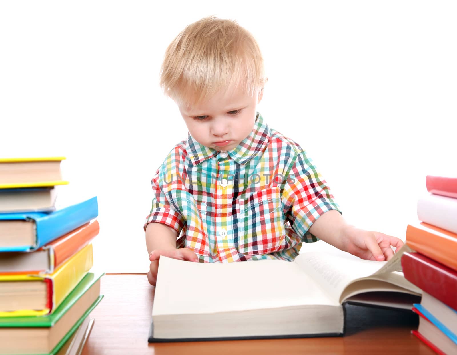 Baby Boy with the Books at the Desk Isolated on the White Background