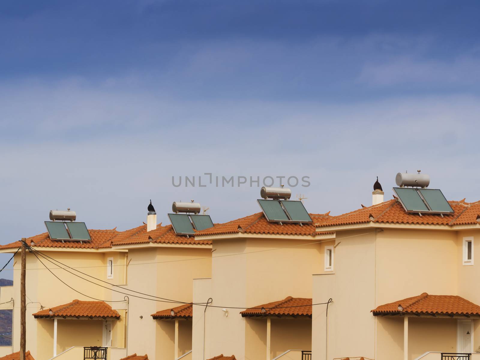Contemporary hot water solar panels on an apartment house roof