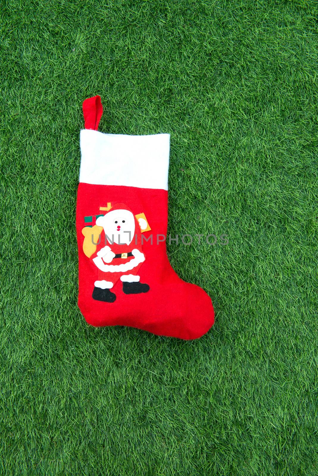 Close up of christmas socks on Green grass background