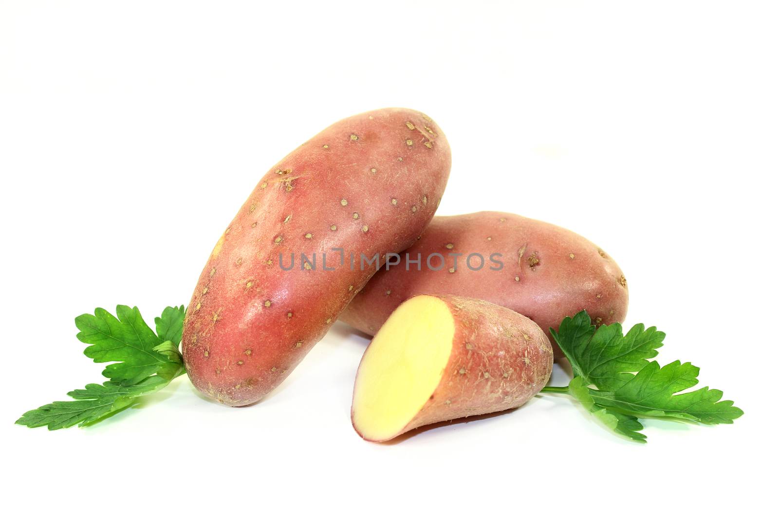 raw, red potatoes on a white background