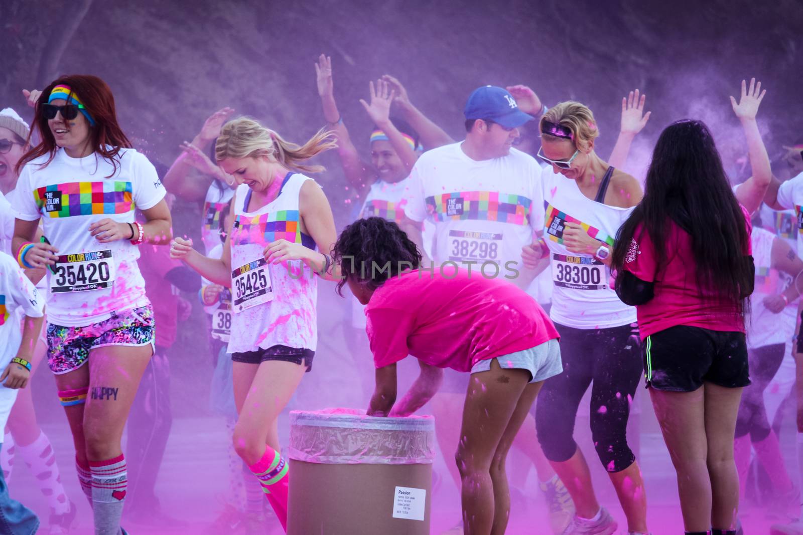 Ventura, CA - OCTOBER 18 : Participants coming through the pink color station at The Color Run 2014 in Ventura. OCTOBER 18, 2014 in Ventura, CA.