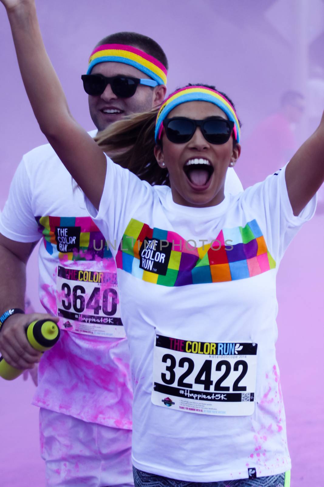 Ventura, CA - OCTOBER 18 : Participants coming through the pink color station at The Color Run 2014 in Ventura. OCTOBER 18, 2014 in Ventura, CA.