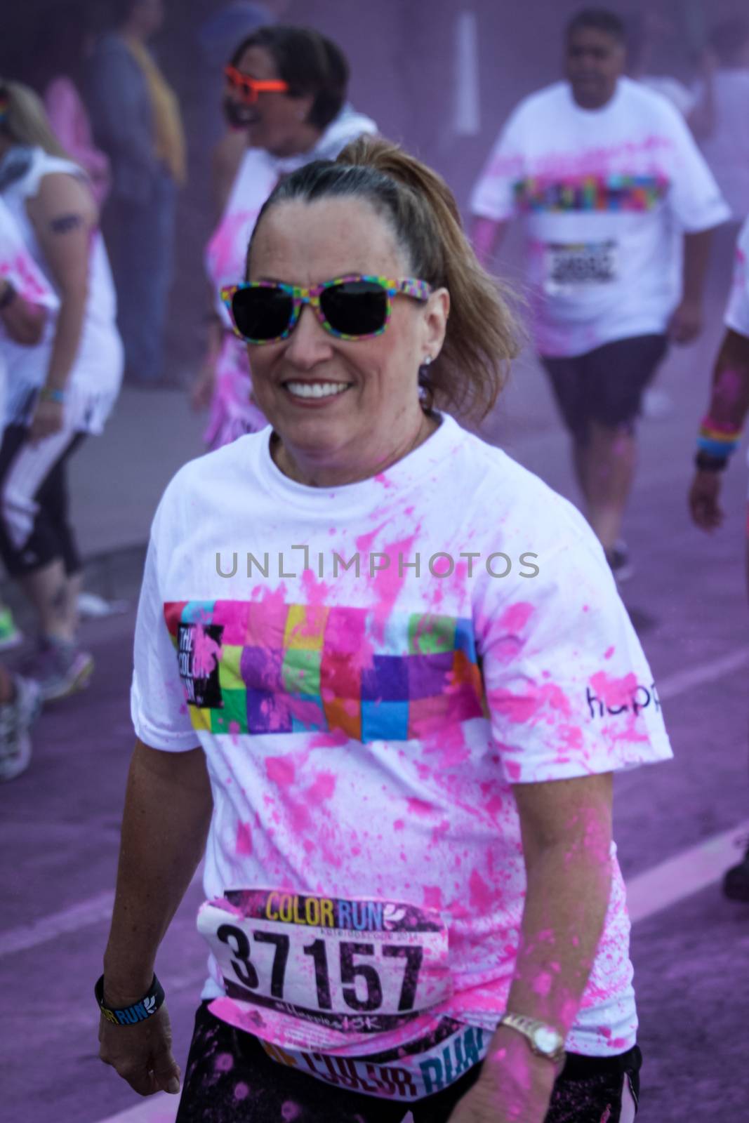 Ventura, CA - OCTOBER 18 : Participants coming through the pink color station at The Color Run 2014 in Ventura. OCTOBER 18, 2014 in Ventura, CA.