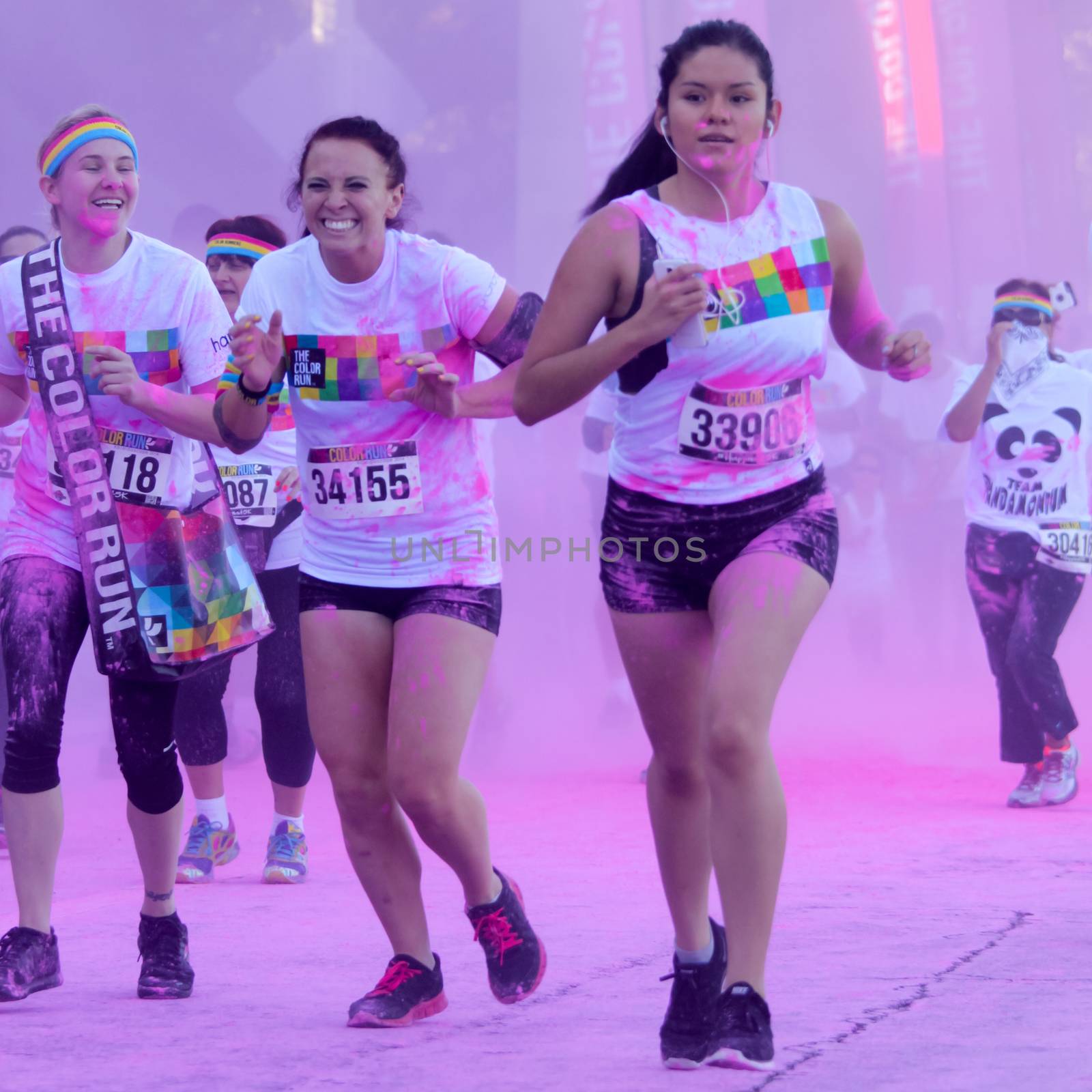 Ventura, CA - OCTOBER 18 : Participants coming through the pink color station at The Color Run 2014 in Ventura. OCTOBER 18, 2014 in Ventura, CA.