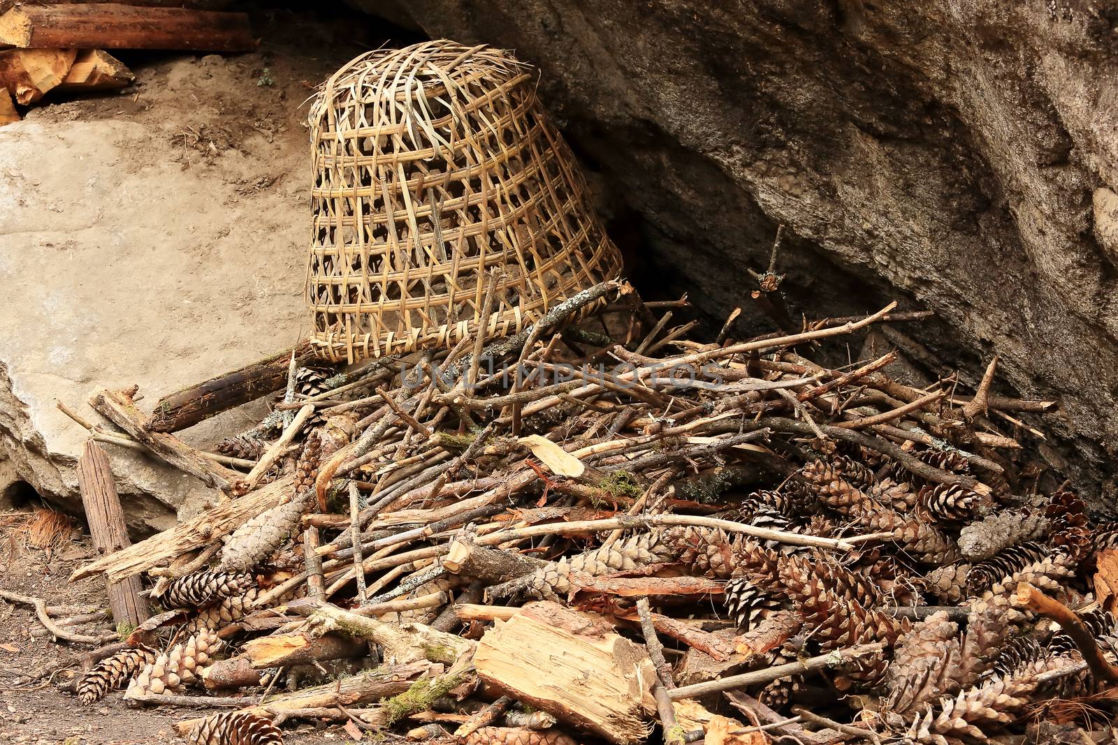 Old Nepalese basket lies on a pine cones near the rock. Nepal.