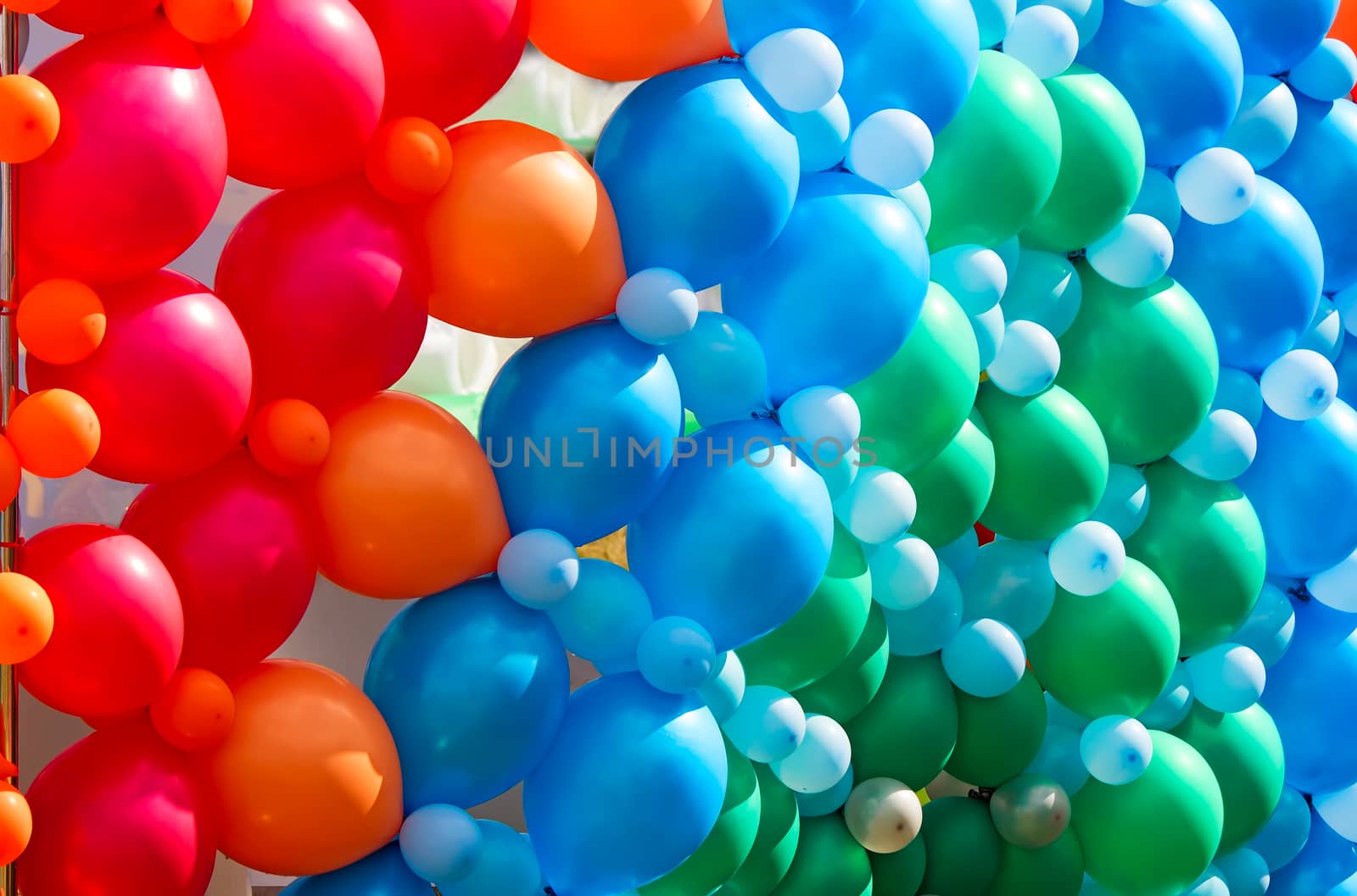 A large number of beautiful red, blue and green balloons, decoration for the holiday.