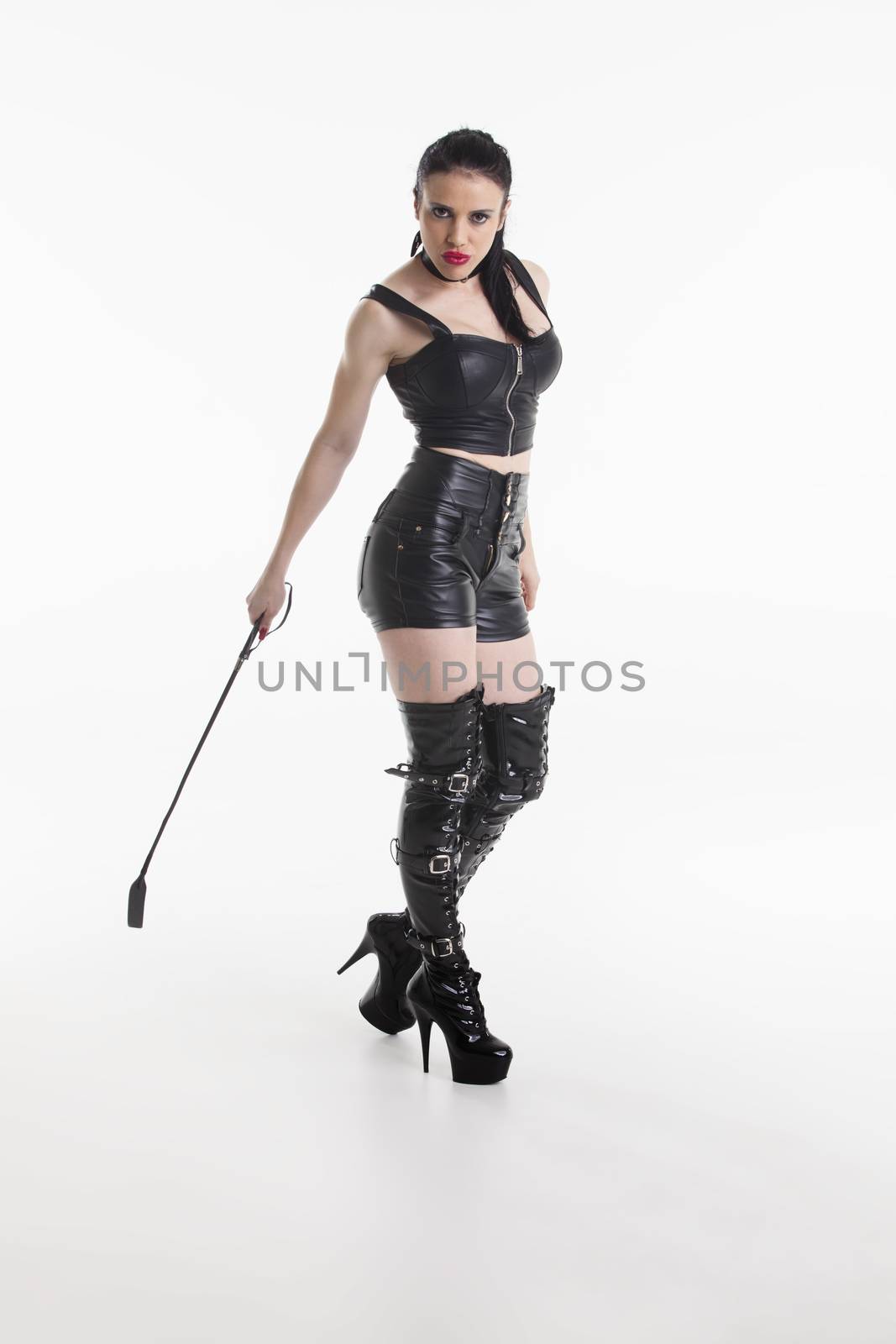 domina in leather with a whip