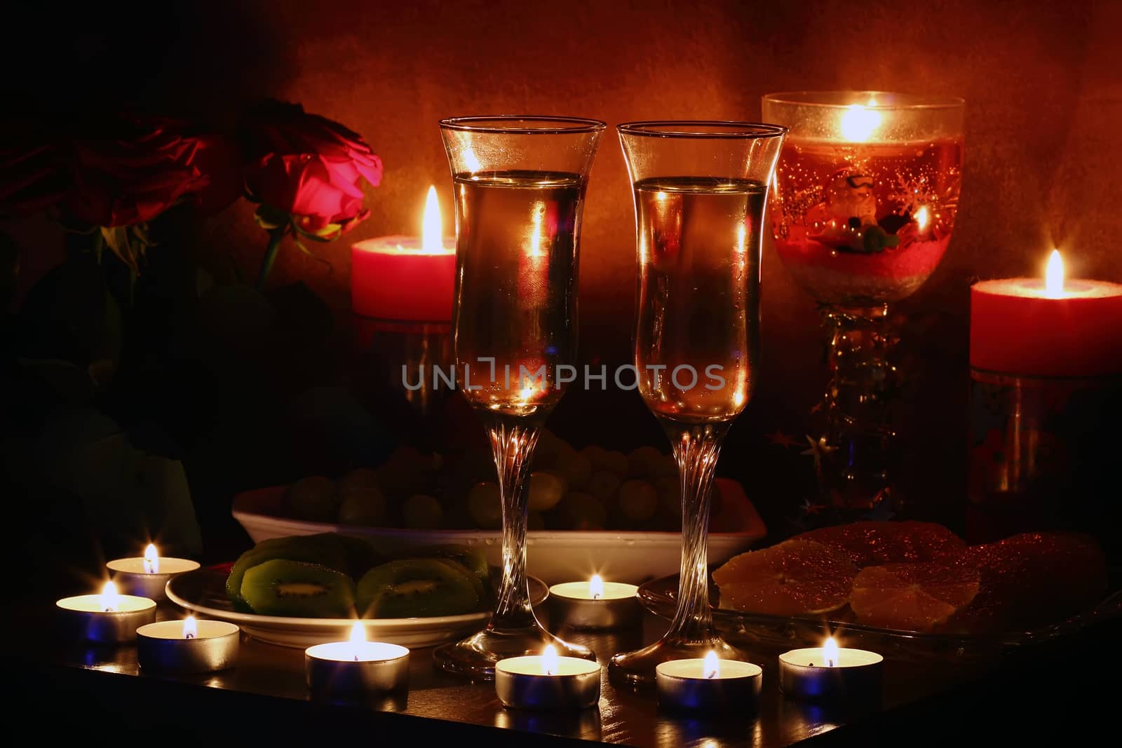 Champagne, fruit, candles and a romantic evening 