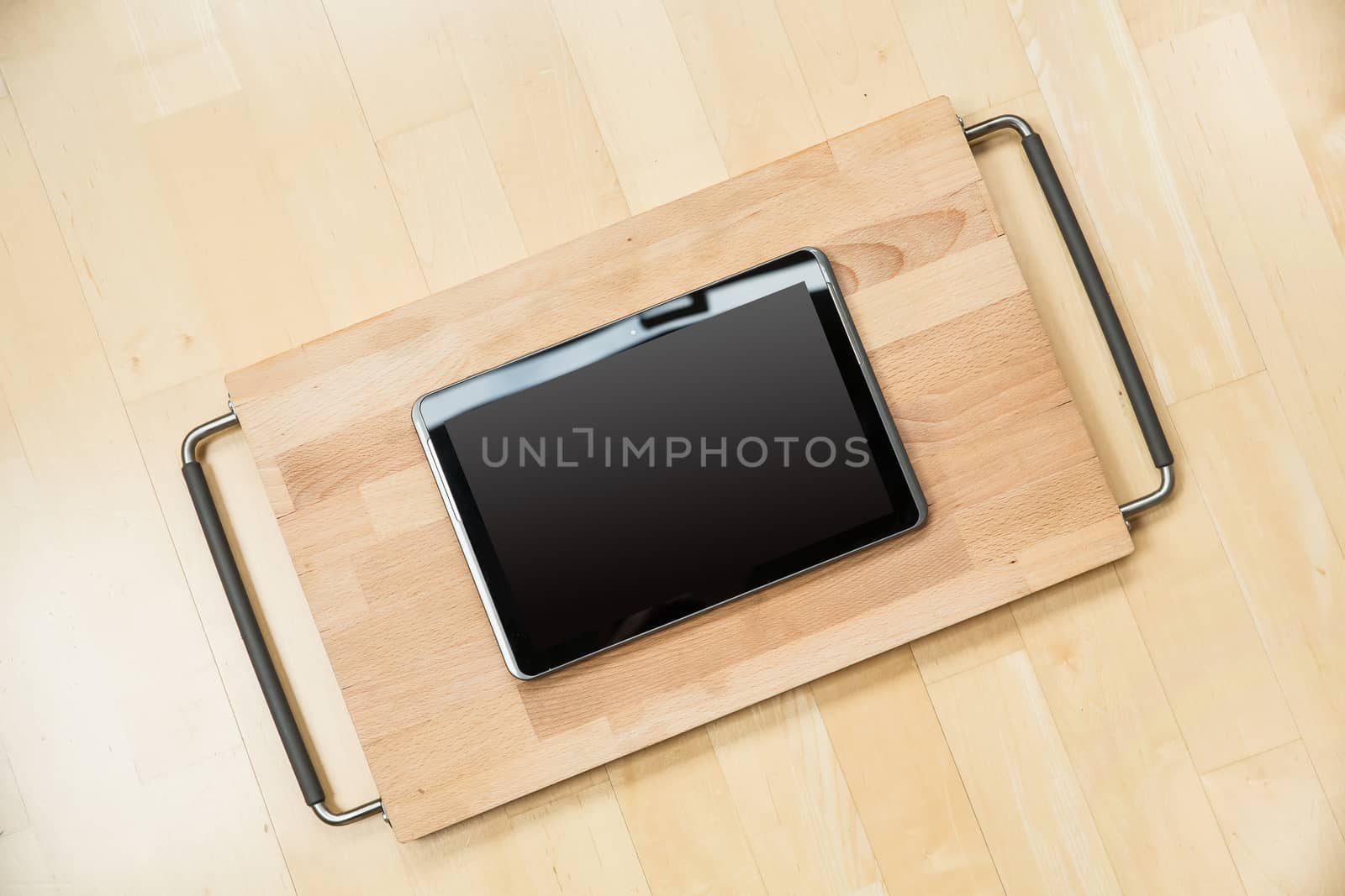 A Tablet PC on a cutting board.