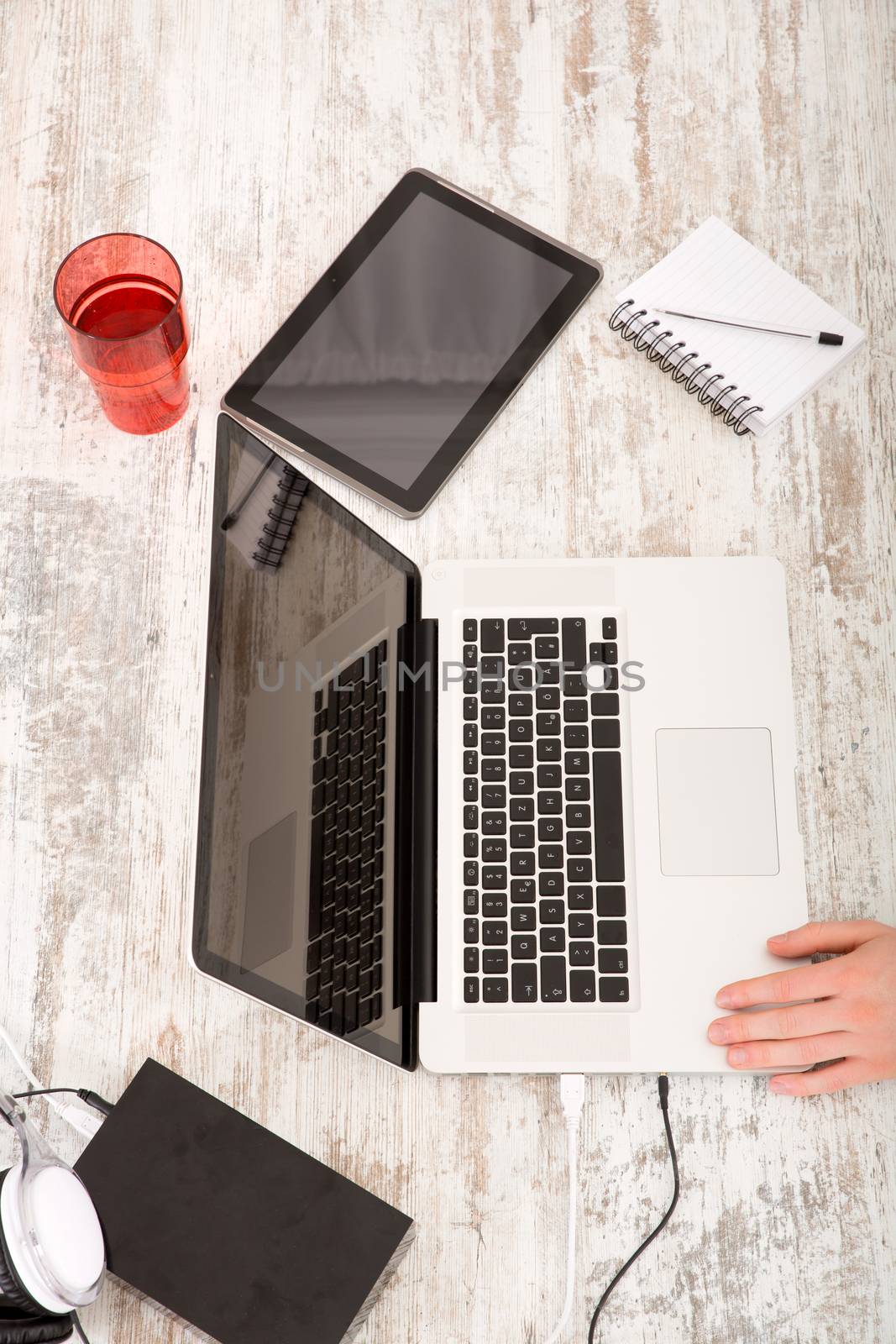 A home office with a laptop and tablet.
