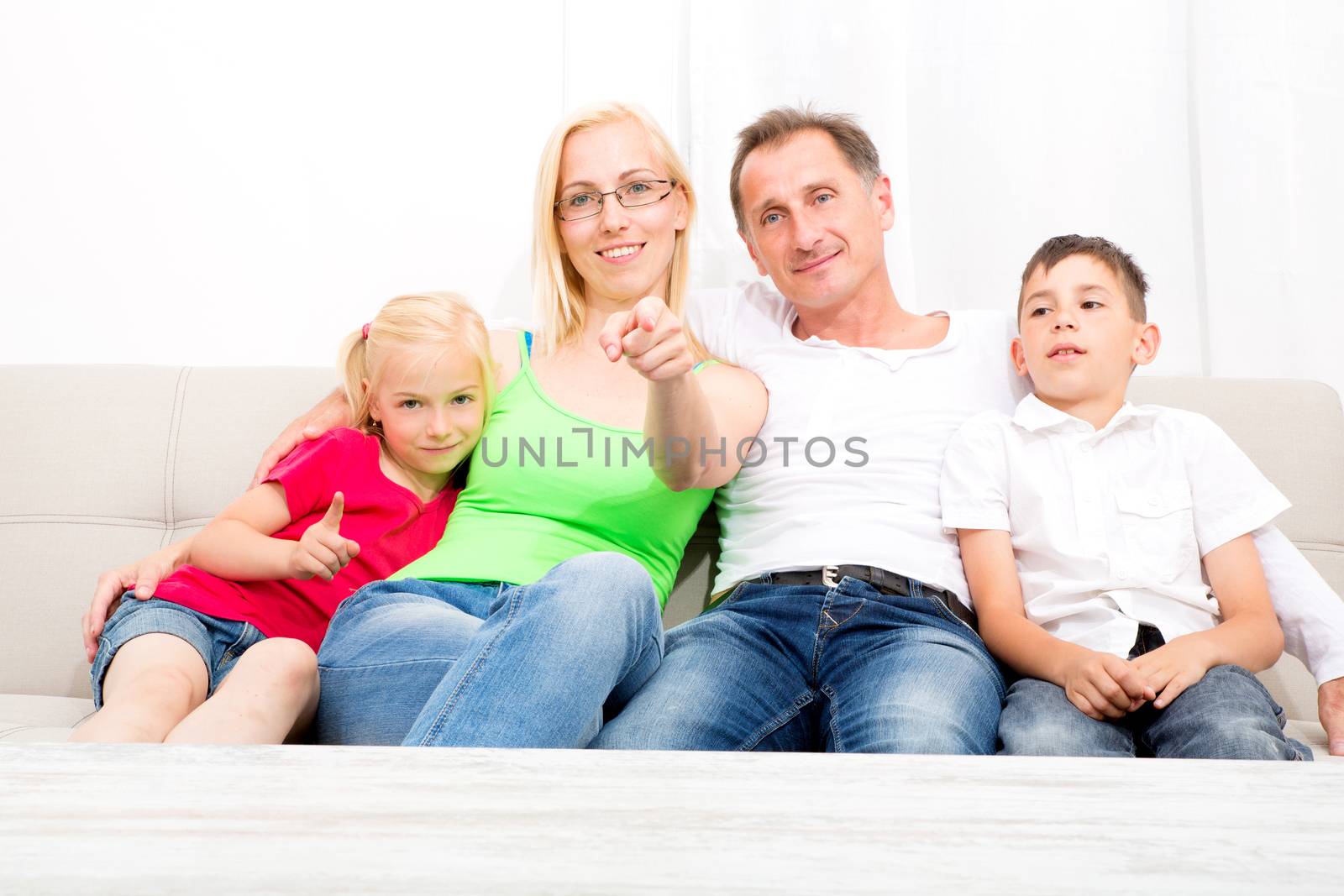 Happy family sitting together on the couch
