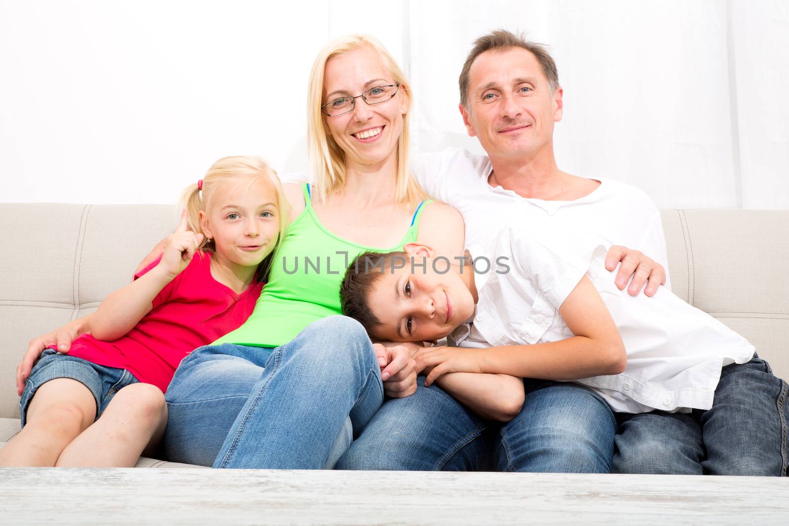 A happy Family at home on the sofa.