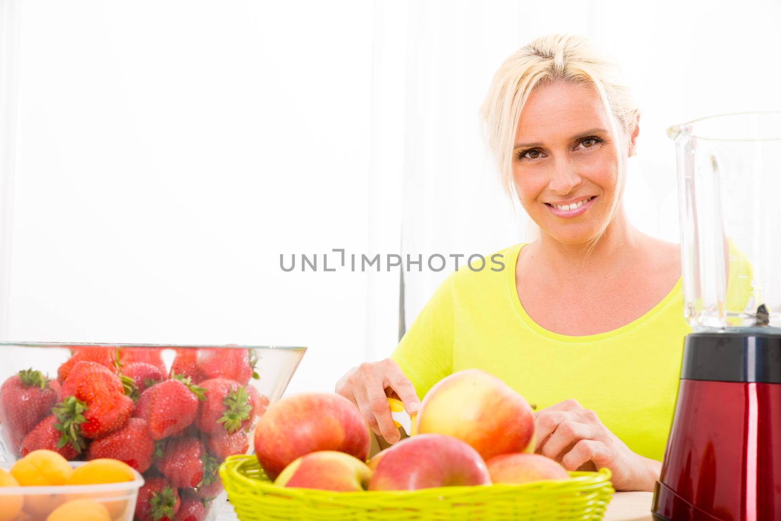 Mature woman preparing a smoothie by Spectral