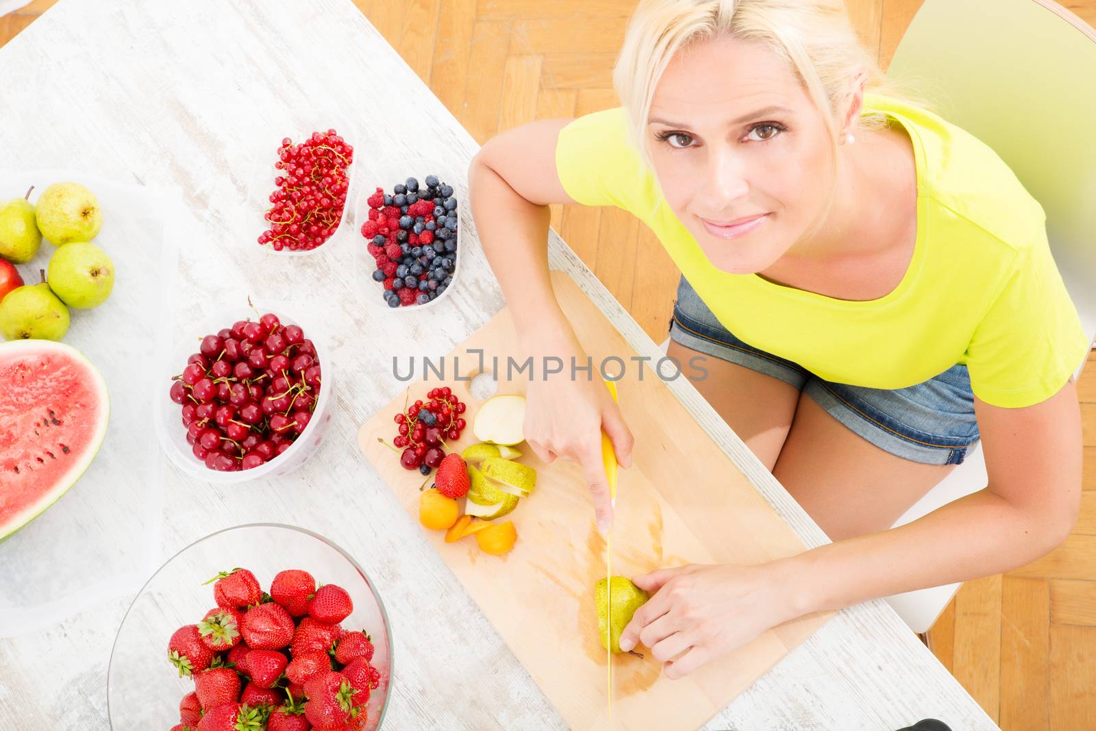 Mature woman preparing a smoothie by Spectral