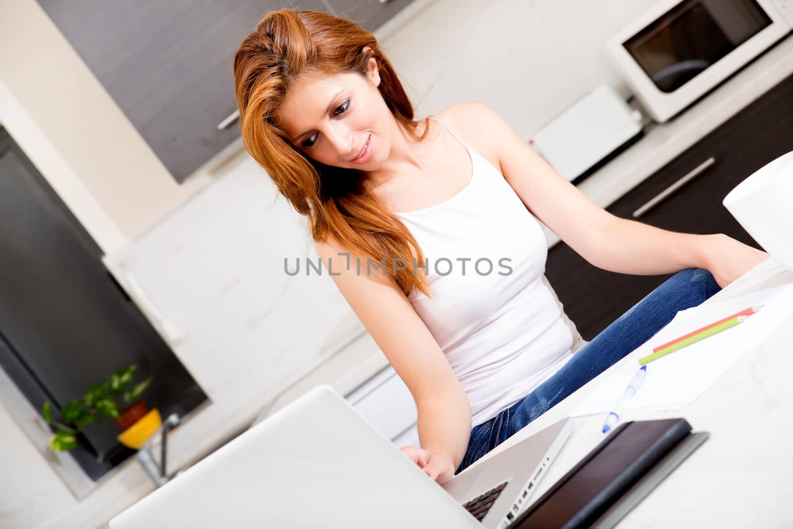 Portrait of a brunette girl working in the kitchen.