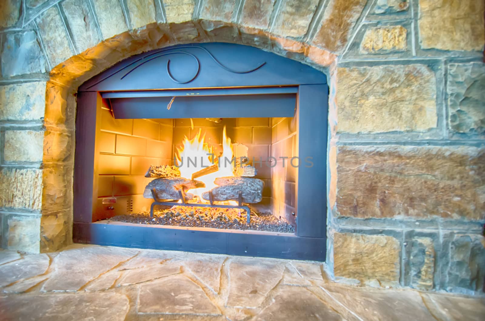 luxurious stone structure fireplace with burning fire by digidreamgrafix