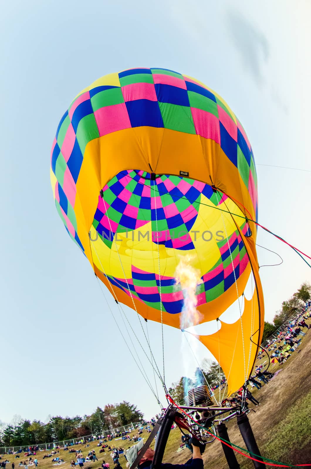 Fire heats the air inside a hot air balloon at balloon festival 