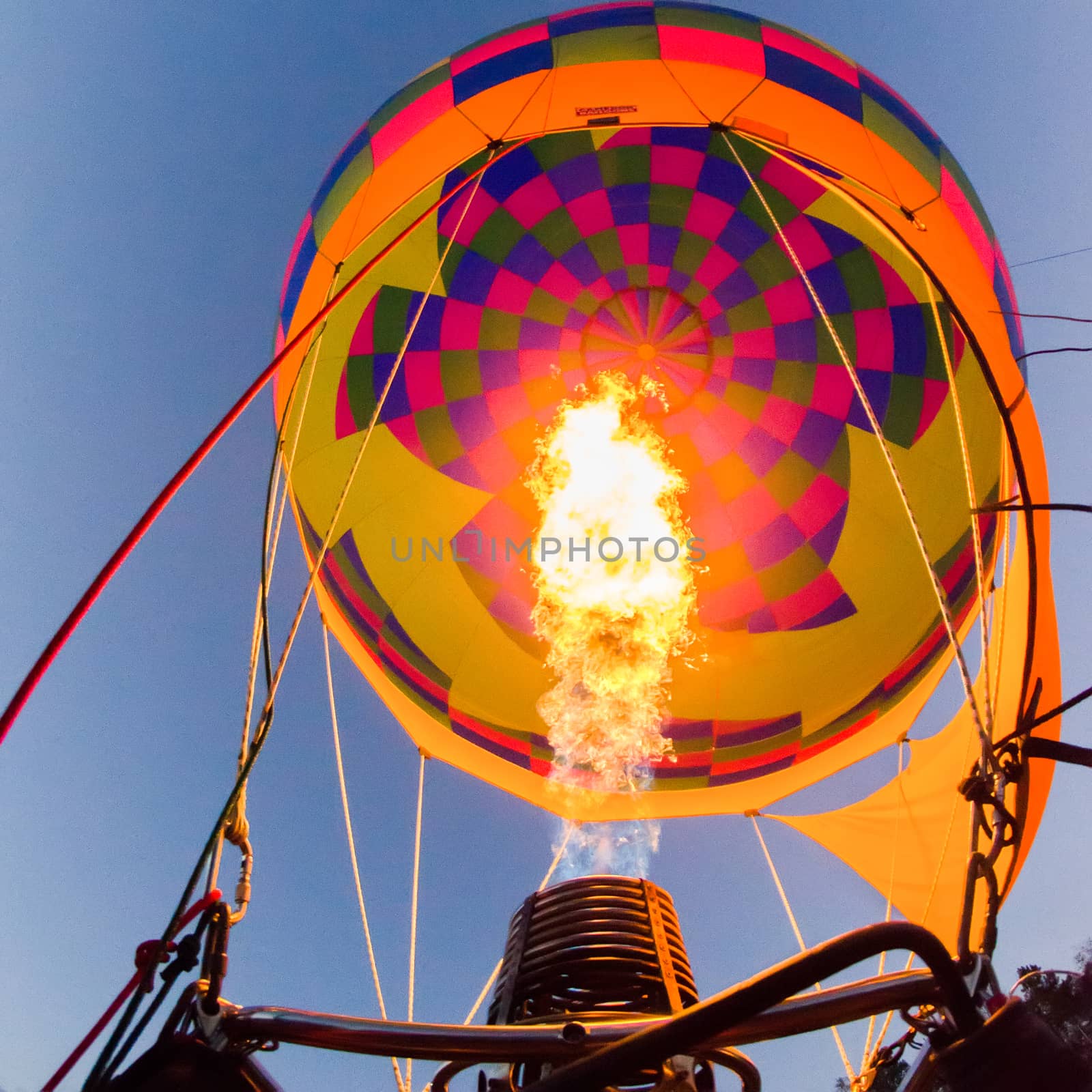 Fire heats the air inside a hot air balloon at balloon festival  by digidreamgrafix