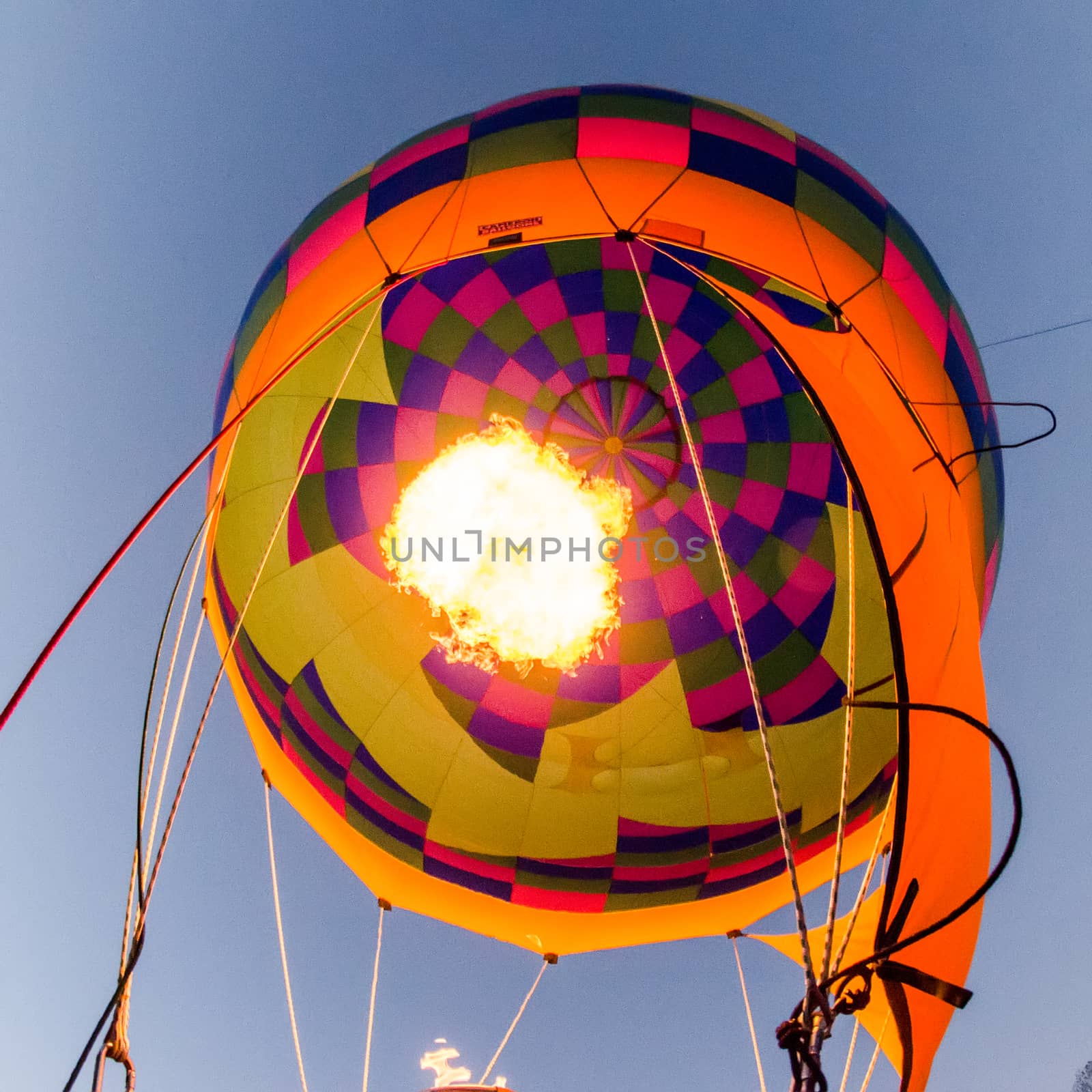Fire heats the air inside a hot air balloon at balloon festival 