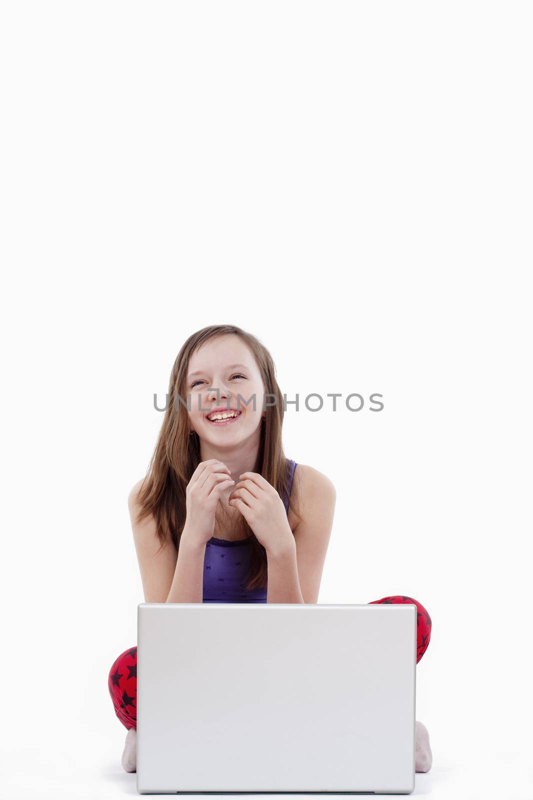 young girl with laptop computer smiling - isolated on white