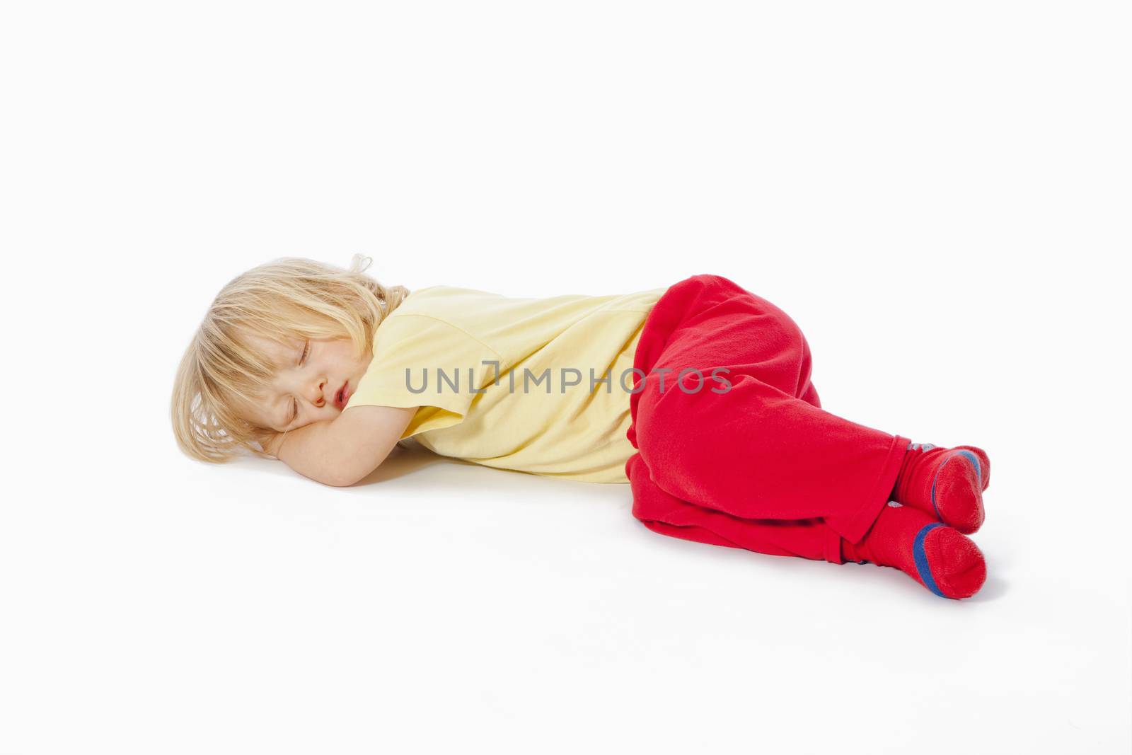 beautiful boy with long blond hair sleeping on the floor