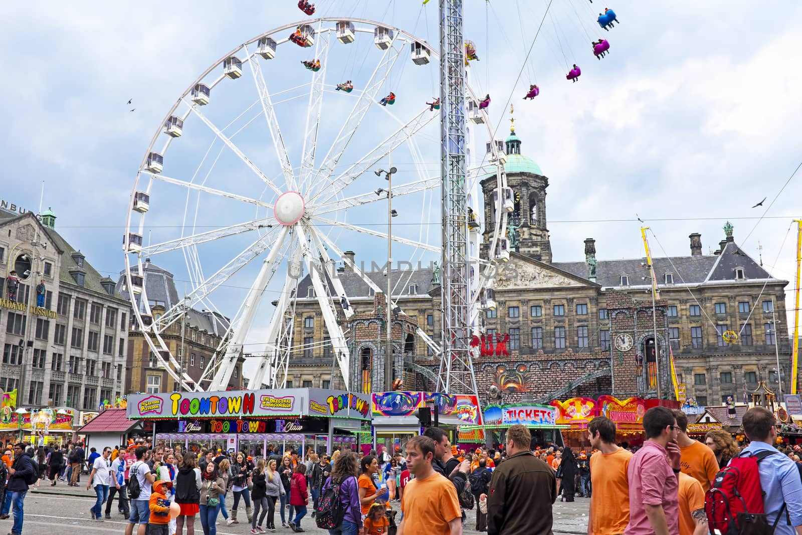 AMSTERDAM - APRIL 26: On the Dam square people in orange celebrating kings day on April 26, 2014 in Amsterdam, The Netherlands
