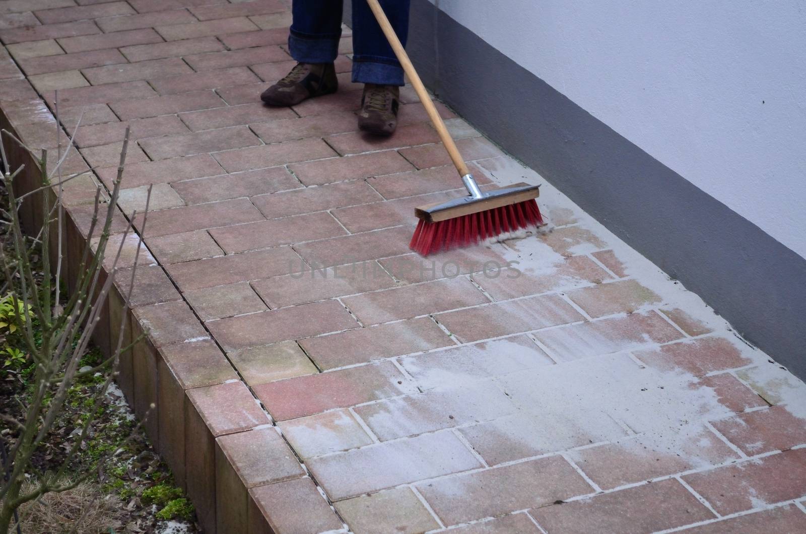 Sand in paving joint sweep it, grouting.
The new broom sweeps clean.