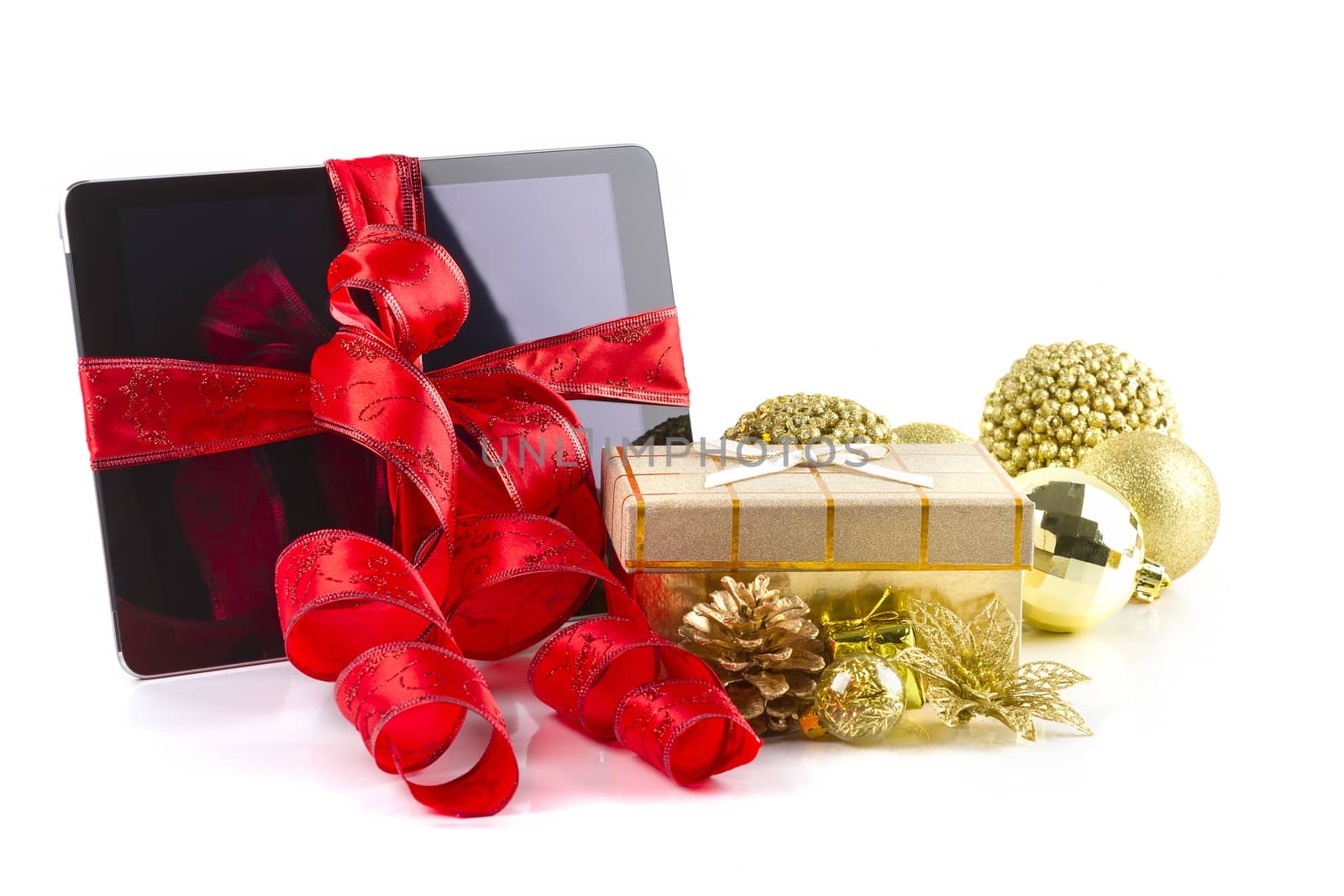 tablet pc with  christmas decorations on white  by manaemedia