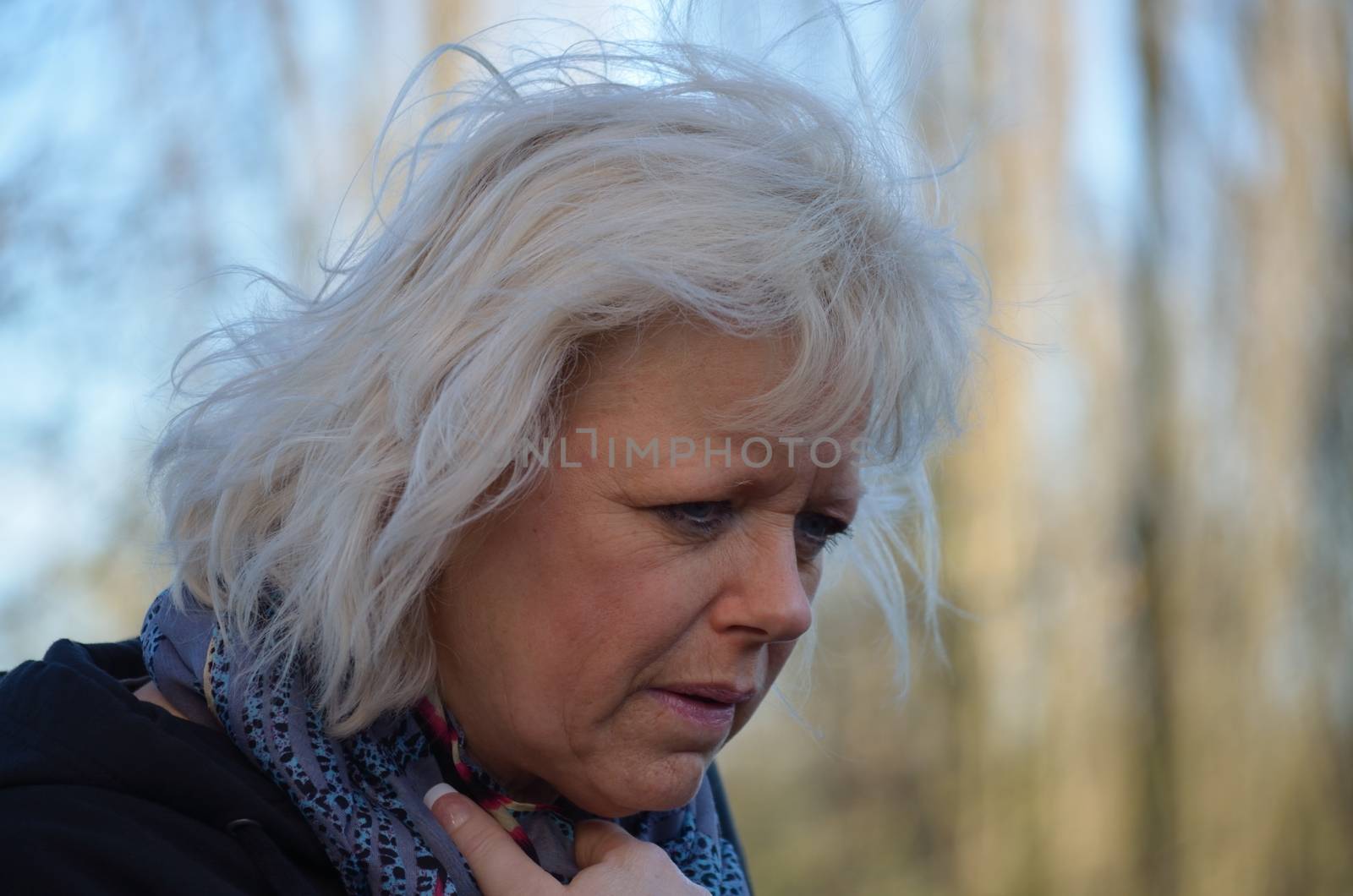 A woman with blond hair while walking depends their thoughts afterwards.