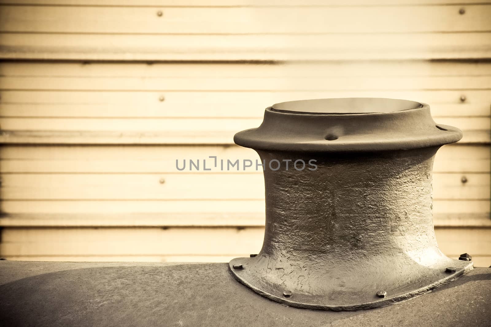 steam escaping from the funnel of a vintage railroad engine