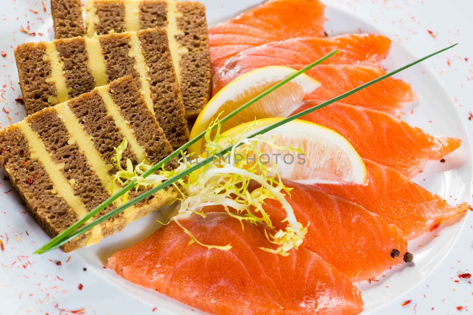 Salmon snack on the white plate, studio shot