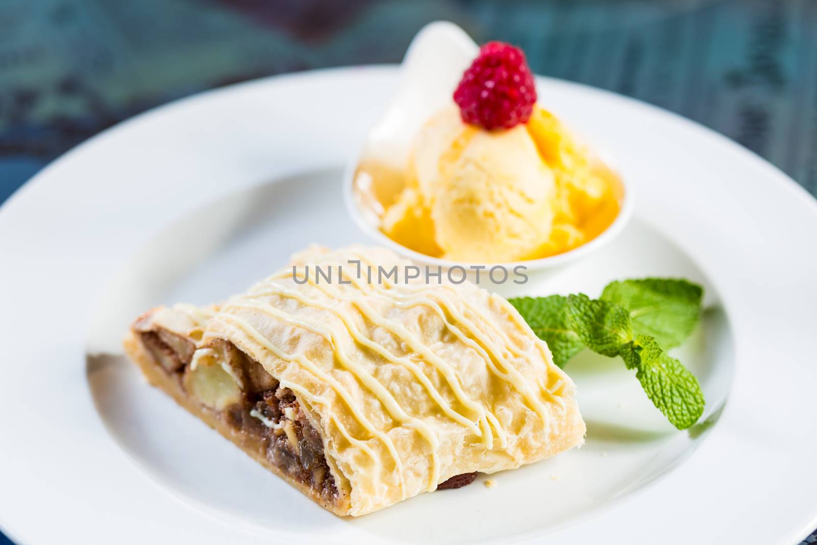 Apple strudel with icing sugar,almonds and vanilla ice cream by sarymsakov