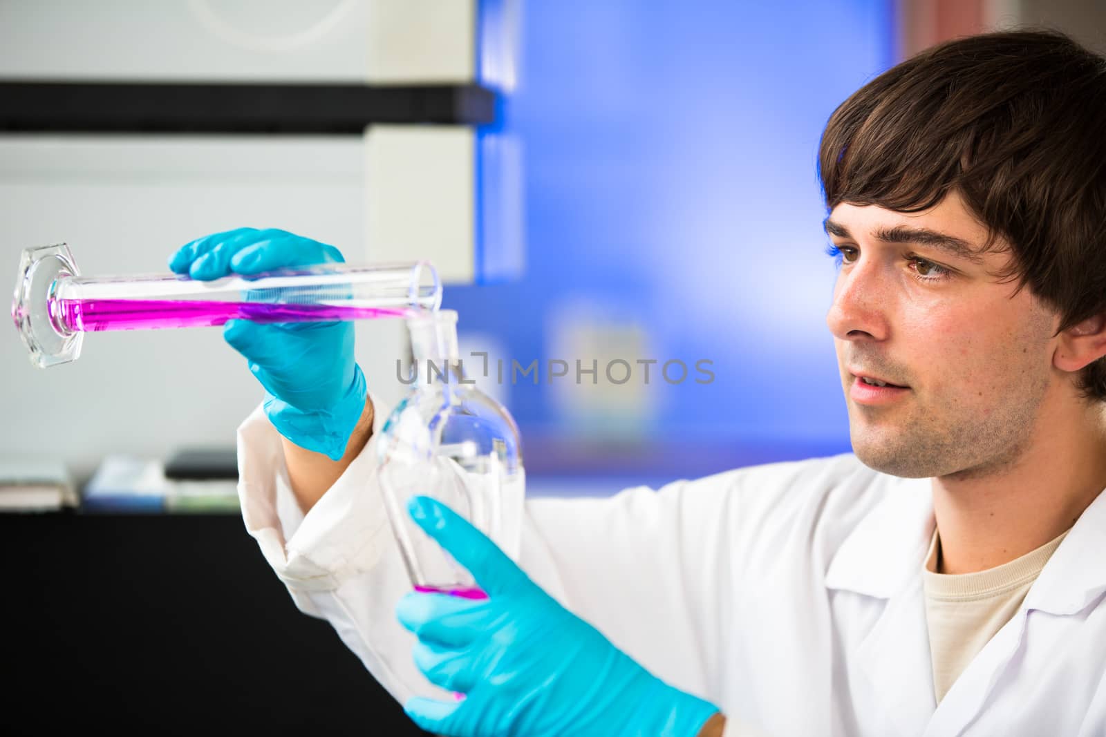 Young male researcher carrying out scientific research in a lab (shallow DOF; color toned image)