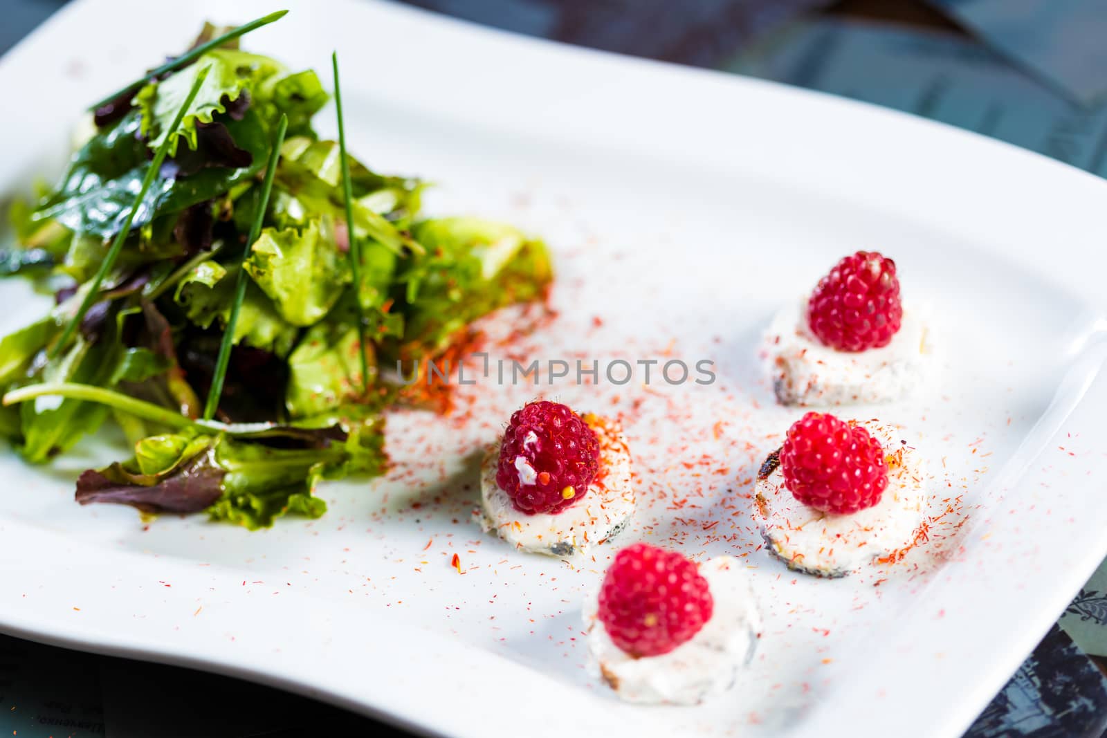 fresh salad with goat cheese and raspberry. by sarymsakov
