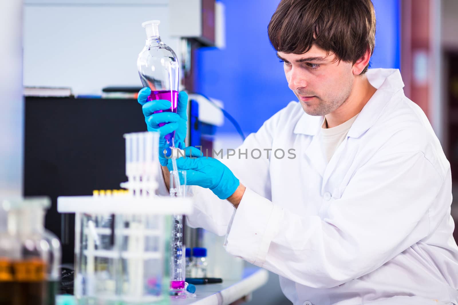 Young male researcher carrying out scientific research in a lab  by viktor_cap