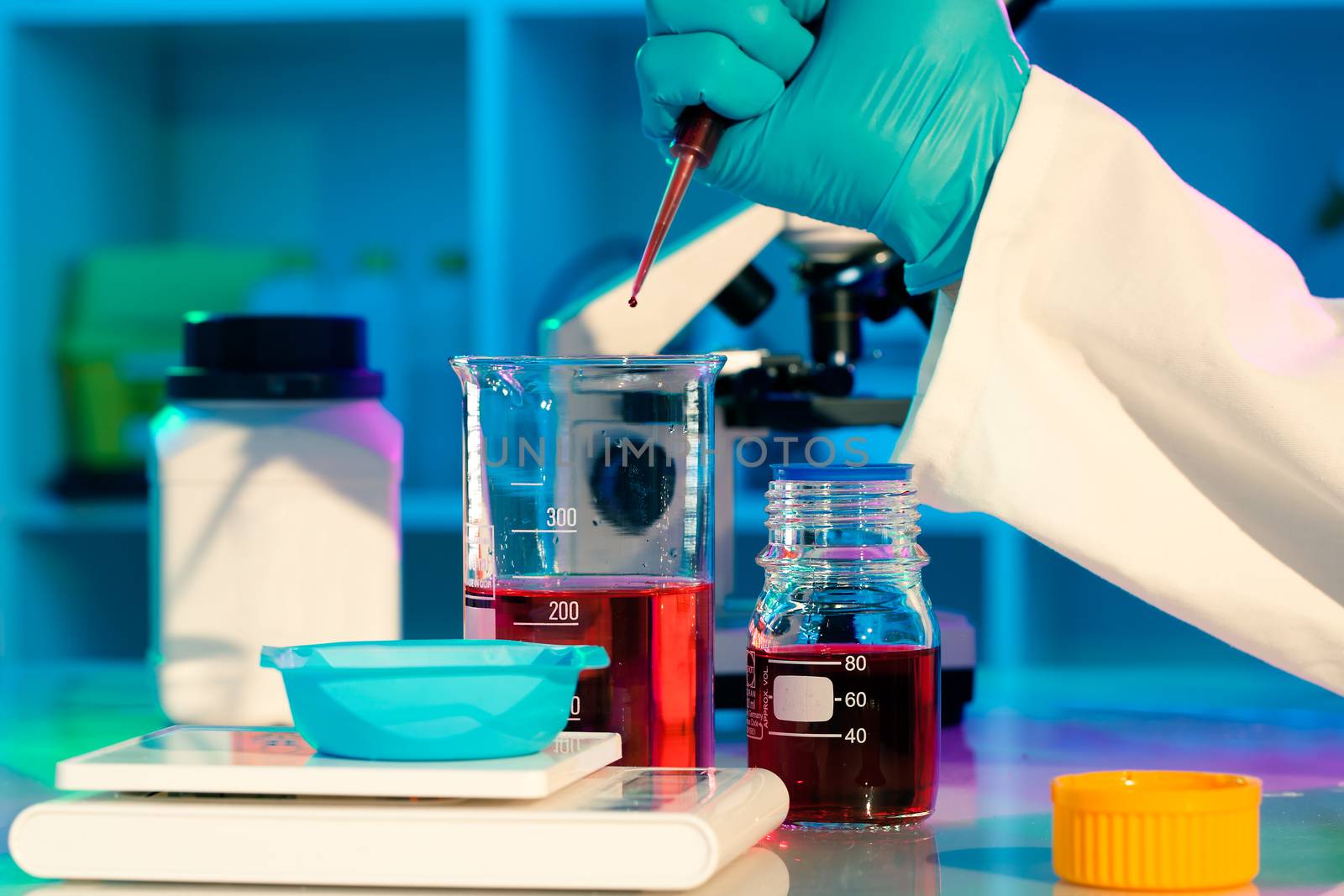 researchers work in modern scientific lab. Preparation of hazardous solution