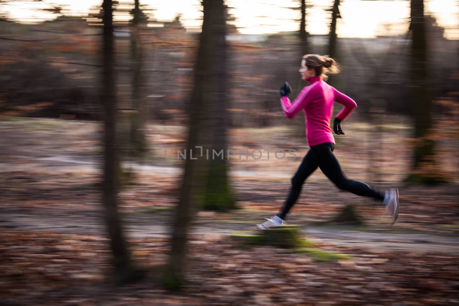 Young woman running outdoors in a city park by viktor_cap
