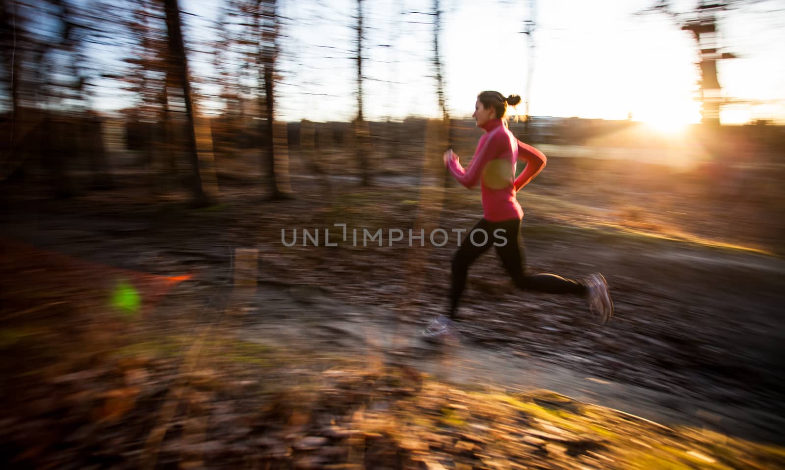 Young woman running outdoors in a city park by viktor_cap