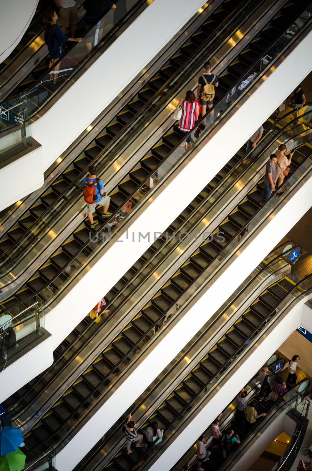 Bangkok, Thailand - September 12, 2013: Crowd on escalator at Terminal21 shopping mall by siraanamwong