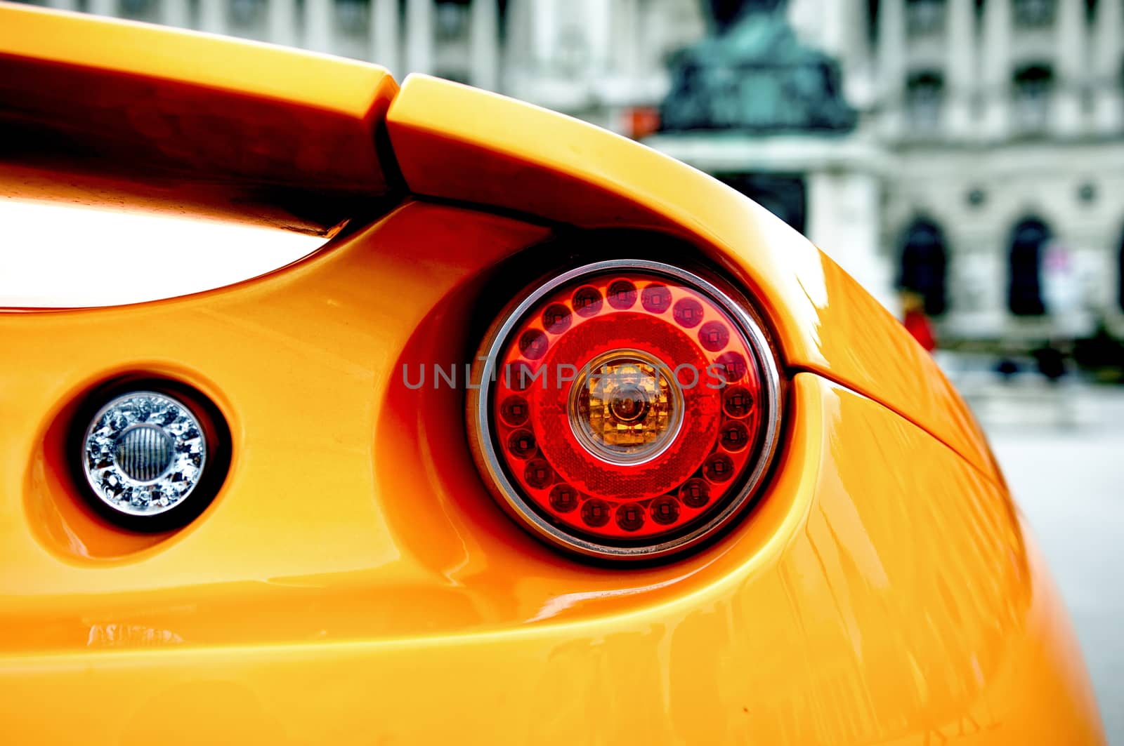 Back of an orange sports car by anderm