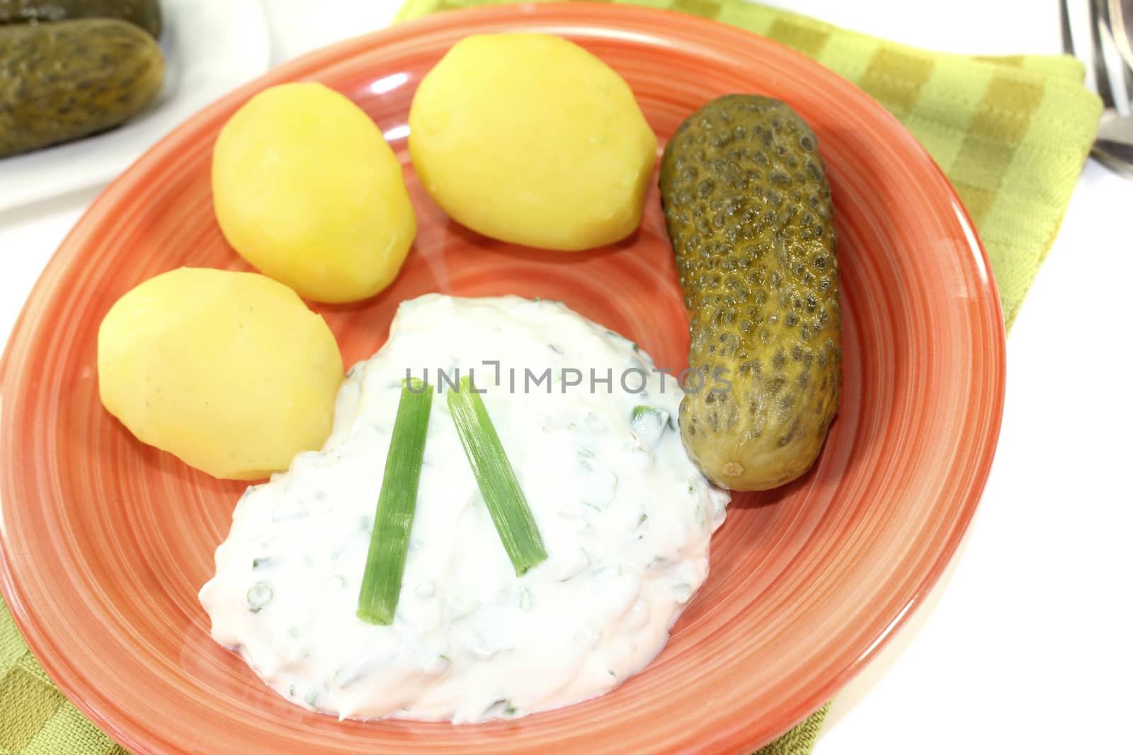 Potatoes with curd and chives on a light background