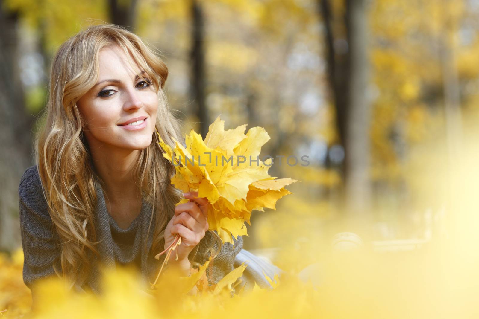 Portrait of beautiful young woman outdoors in autumn park