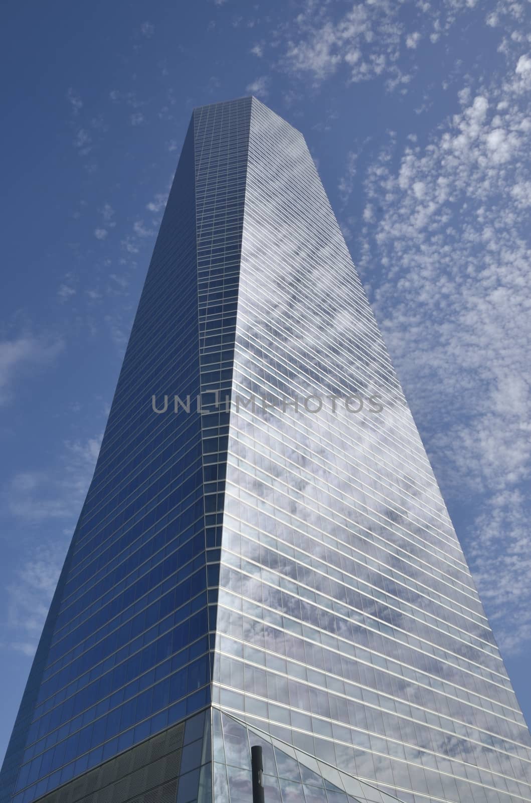 Clouds reflected in the Crystal Tower in the Four Towers Business Area, Madrid, Spain.  
The Crystal tower was designed by Pelli.