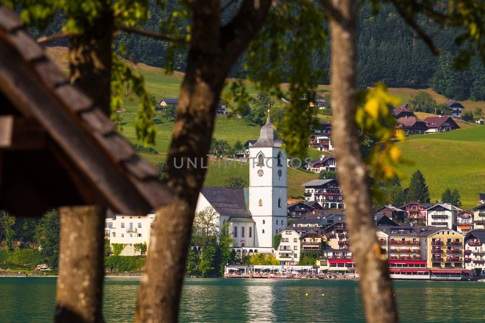 View of St. Wolfgang village waterfront at Wolfgangsee lake with beach toys in front, Austria