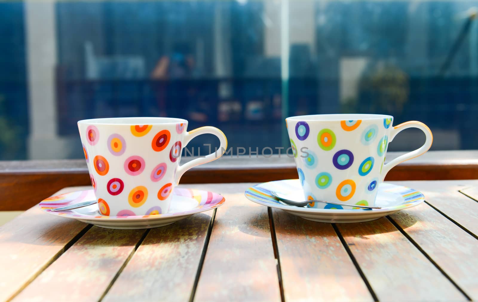 Colorful cup of coffee on wooden table 