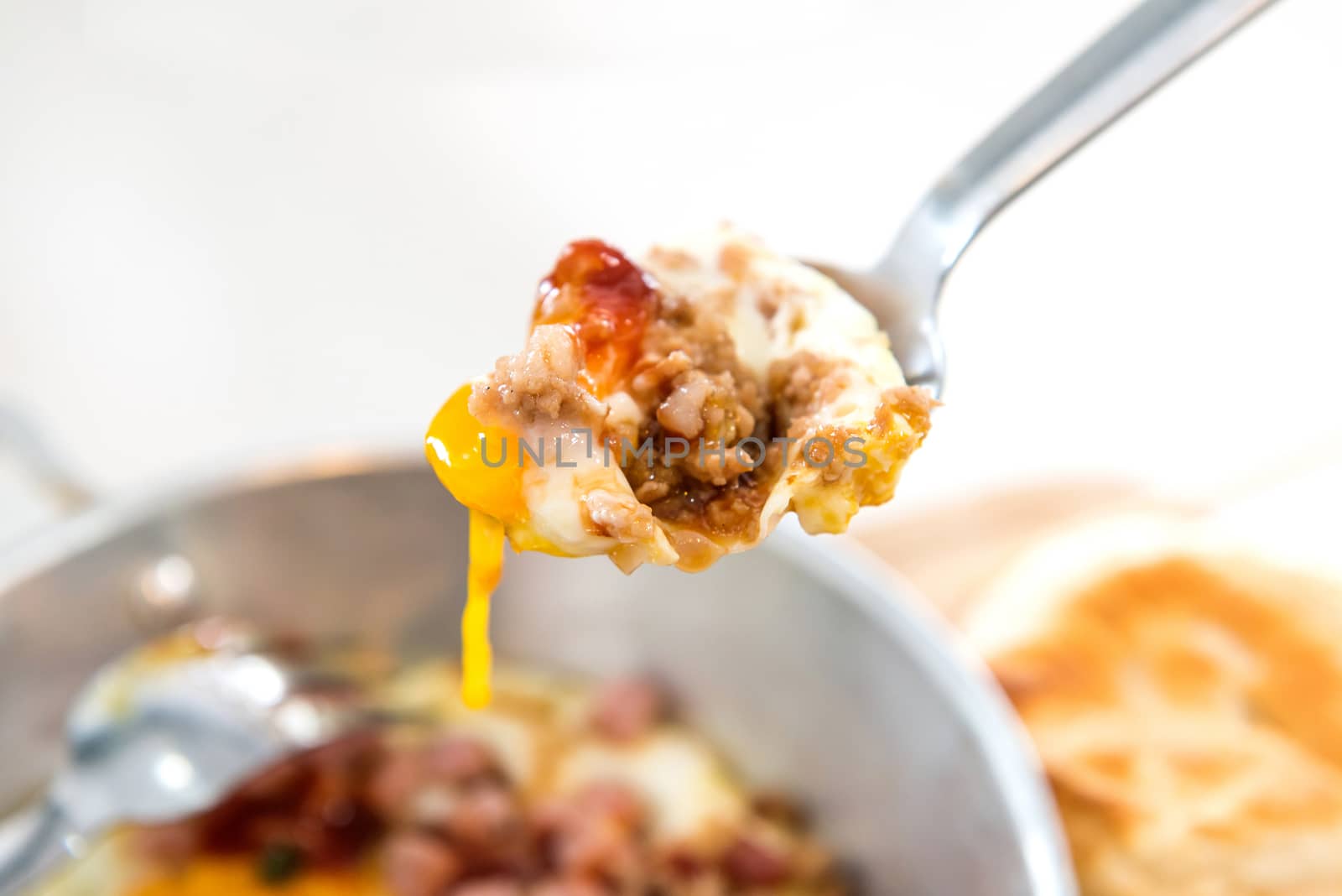 Healthy breakfast - fried eggs and pork in spoon