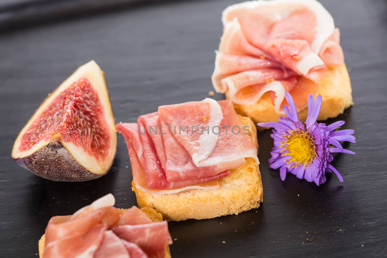 Slices of figs in Prosciutto Italian cured ham