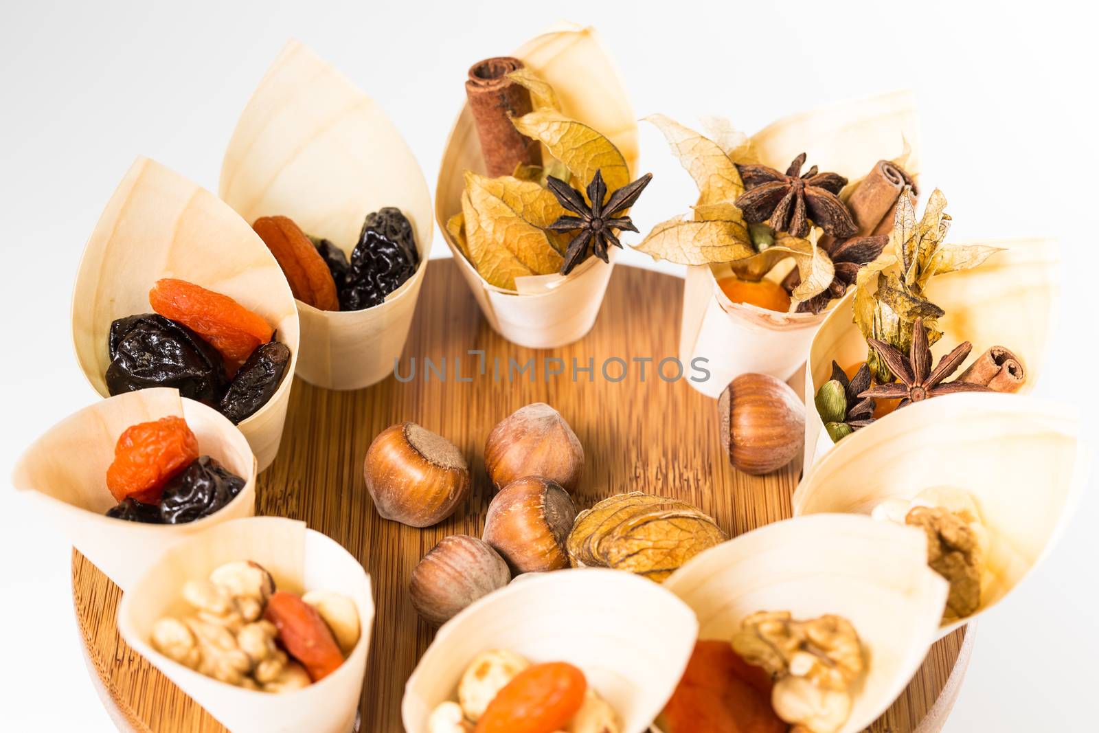 Mix nuts, dry fruits and chocolate on a white background