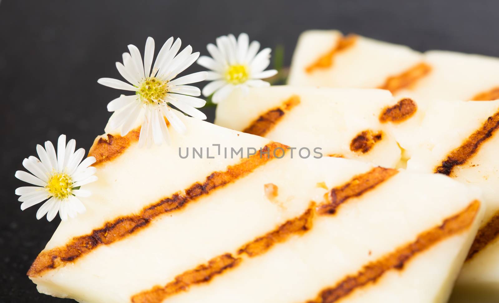 Halloumi cheese frying in grill pan. Closeup